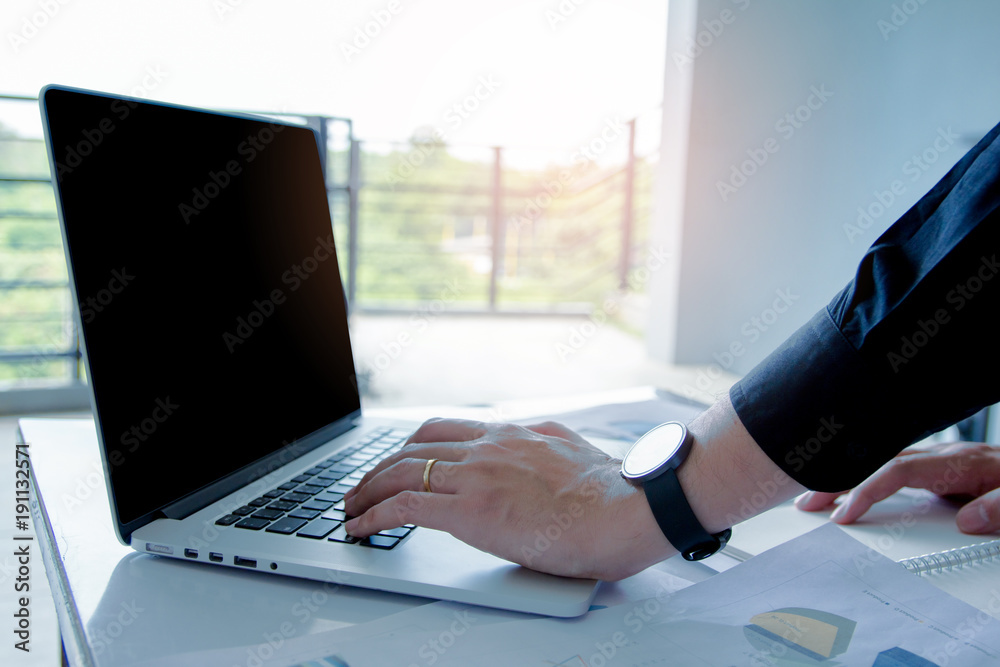 Fototapeta premium Close up. Man Working on laptop connecting networking Concept,Teamwork,With sunset,Selective Focus.
