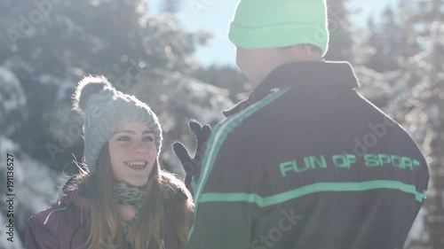 Young woman stealing her boyfreind's hat and running away