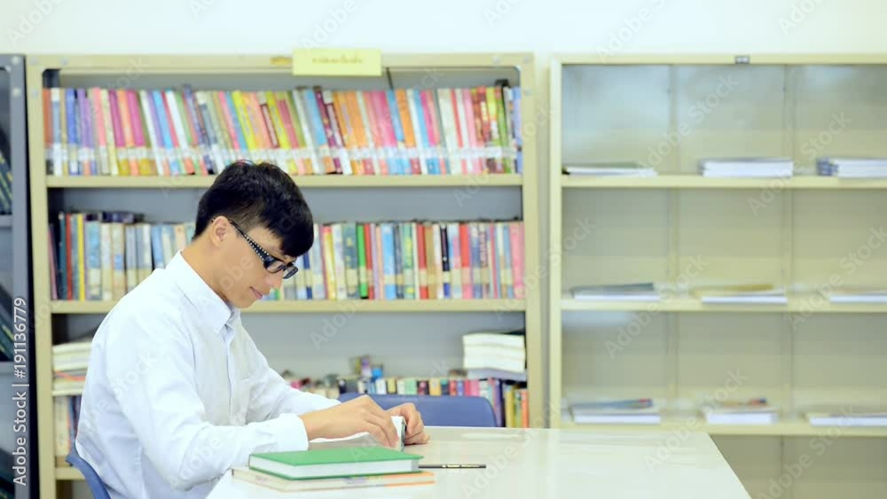 Student in library. Young Chinese male student study in library. Student in library. Young Chinese male student study in library.