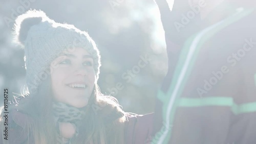 Close up of young woman stealing her boyfreind's hat and running away