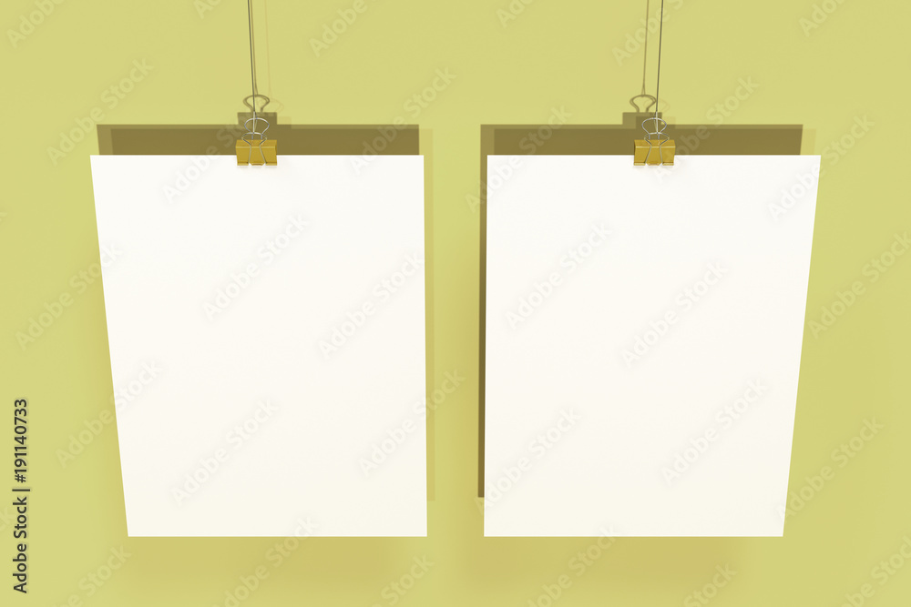 Two blank white posters with binder clip mockup on yellow background Two blank white posters with binder clip mockup on yellow background