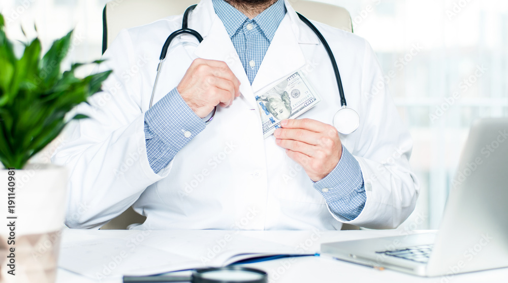 Doctor hiding hundred dollar bill Doctor hiding hundred dollar bill