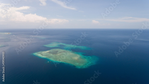 Aerial view coral reef, atoll with turquoise water in the sea.Tropical atoll, coral reef in ocean waters. Travel concept.