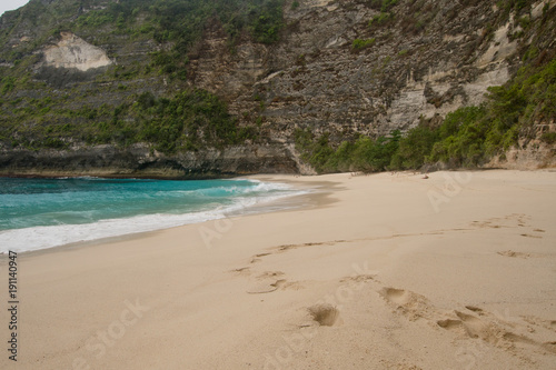 Tropical beach with turquoise water among the rocks, Karang Dawa, Nusa Penida Island, Bali, Indonesia. Travel concept.