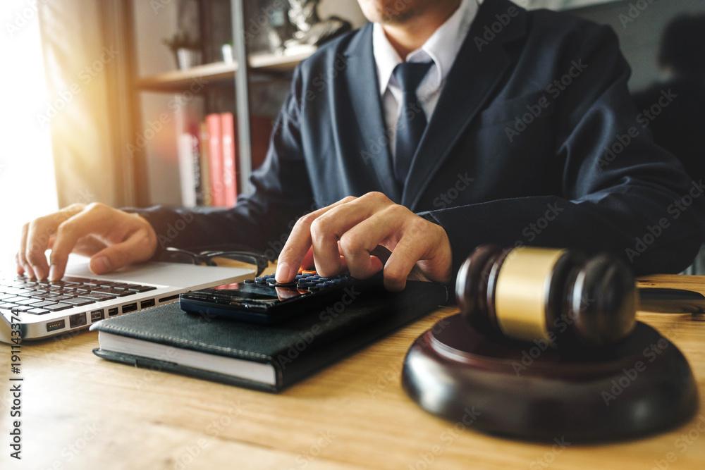 justice and law concept.businessman or lawyer or accountant working on accounts using a calculator and laptop computer and documents in modern office
justice and law concept.businessman or lawyer or accountant working on accounts using a calculator and laptop computer and documents in modern office