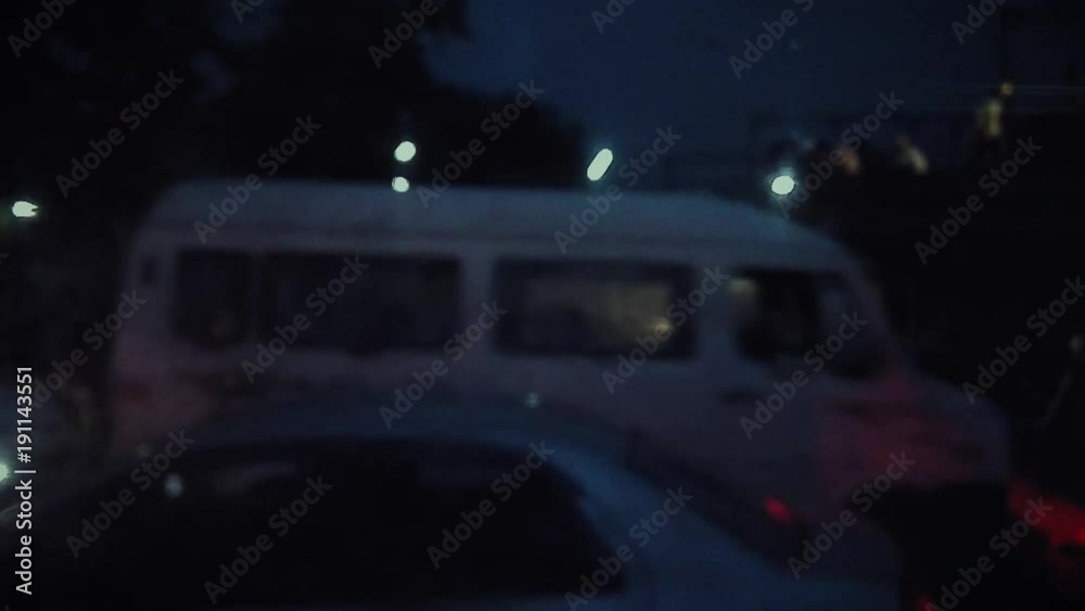 View of traffic movement and vehicle headlights from a dusty bus window. View of traffic movement and vehicle headlights from a dusty bus window.