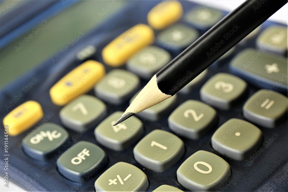An concept image of a calculator with a pencil and copy space An concept image of a calculator with a pencil and copy space