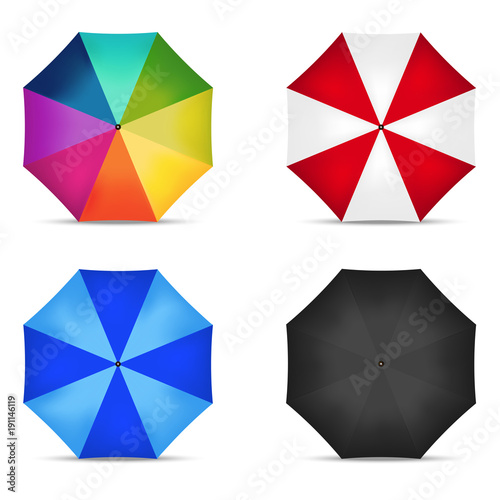 Set of four open multicolored umbrellas on white background