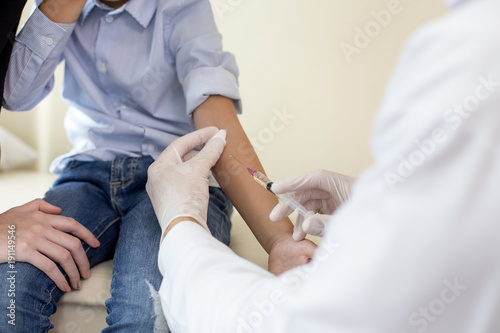 Doctor injection kid at hospital. Kid scary needle when he was inject by doctor. People with medical concept.