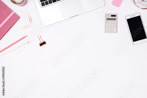 Feminine desk workspace frame with red coffee cup, smartphone and notebook on white background with copy space. Flat lay. Top view.