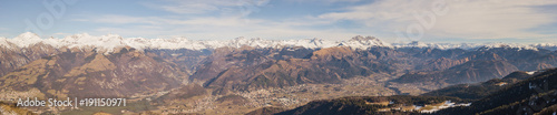 Drone aerial view to the Orobie Alps in a clear and blue day. Fresh snow on the mountains. Panorama from Farno mountain, Bergamo, Italy