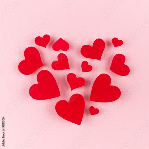 Big heart of soar red hearts on soft pink color background. Concept fof Valentine day.