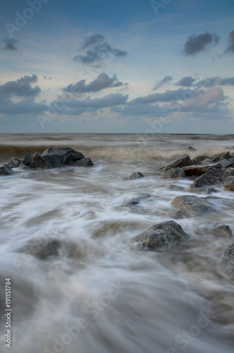 Sea waves lash line impact rock on the beach © NAWAWI