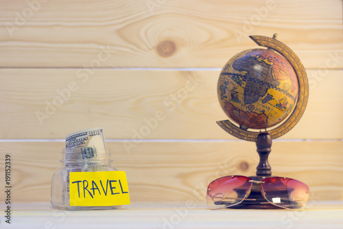 Enjoying vacation planning mood, globe, money and sea shells on white sand background. Instagram photo