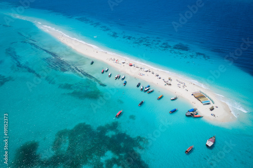 Aerial view of beautiful sand tropical island with white sand beach and tourists, Zanzibar photo