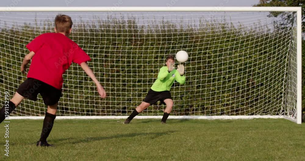 A goalkeeper makes a save from a penalty kick. Shot in slow motion on RED Epic.