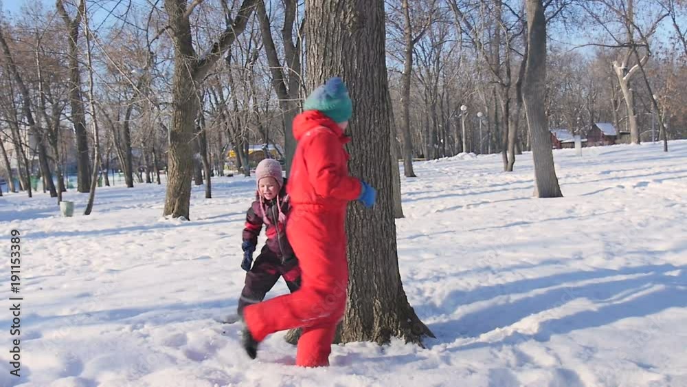 Small children played in the snow in winter