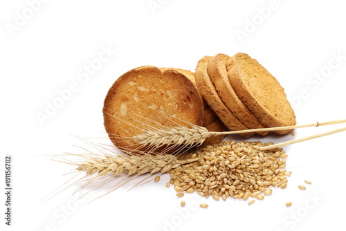 Rusks with integral wholewheat flour, bread slices, ears of wheat and grains isolated on white background