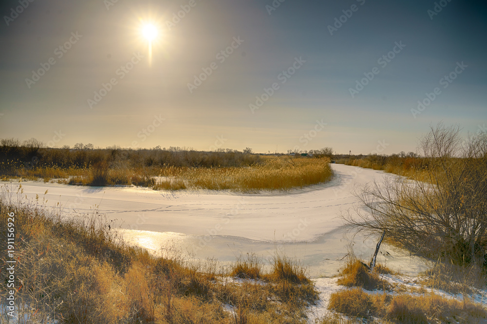 The frozen river. Morning. The sun