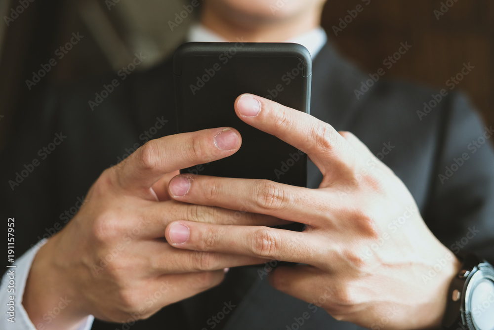 businessman holding smartphone & using app. man texting message outdoors. social network communication, wireless connection, lifestyle concept businessman holding smartphone & using app. man texting message outdoors. social network communication, wireless connection, lifestyle concept