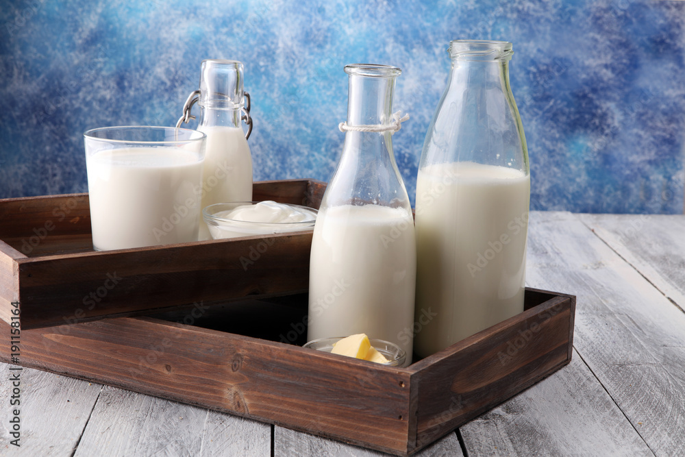 milk products. tasty healthy dairy products on a table on. sour cream in a bowl, cottage cheese bowl, cream in a a bank and milk jar, glass bottle and in a glass milk products. tasty healthy dairy products on a table on. sour cream in a bowl, cottage cheese bowl, cream in a a bank and milk jar, glass bottle and in a glass