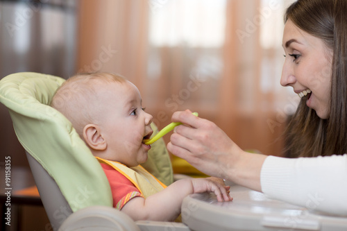 Young woman with baby at ki...
