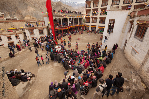 LADAKH, JAMMU AND CASHMIR/ INDIA -JULY 25 2017: Lamas (monks) perform mystic mask dances in Lamayuru Festival at Lamayuru Monastery (gompa) with a ladakhi crowd watching