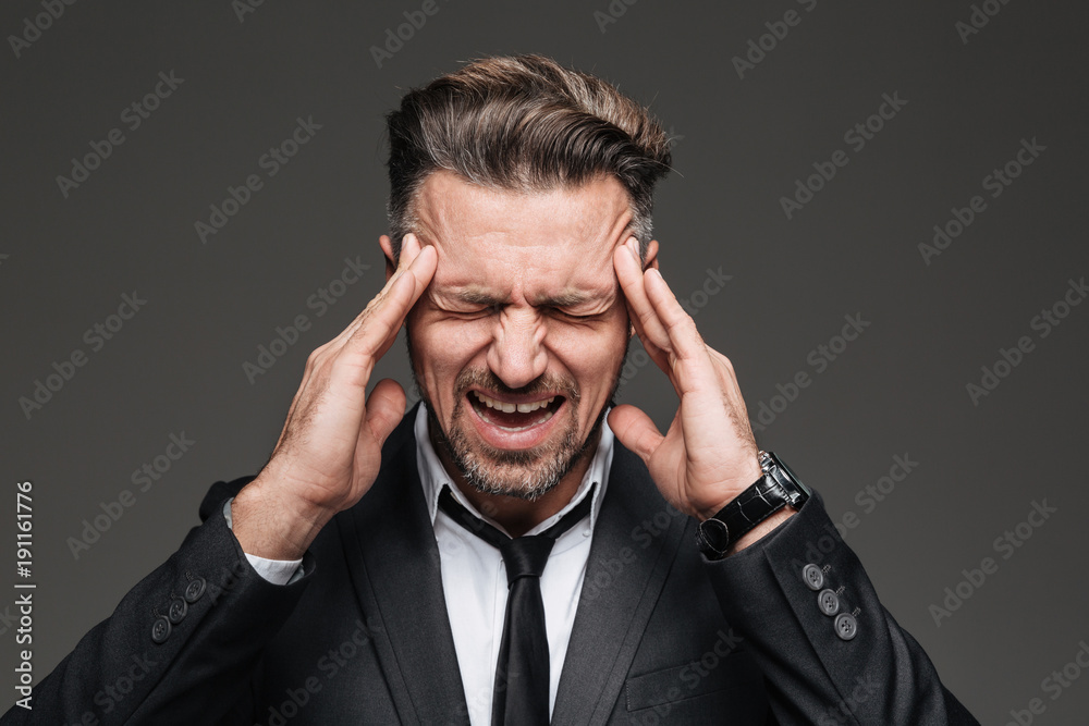 Close up portrait of an overworked mature businessman Close up portrait of an overworked mature businessman