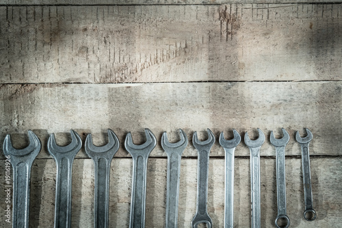 set of metal wrench rests on wooden background abstraction photo