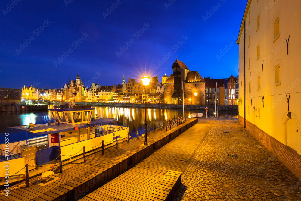 Architecture of the old town in Gdansk over Motlawa river at night, Poland