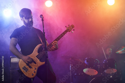 Bass player perform on stage.