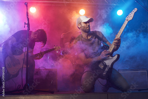 Guitarist and bass player perform on stage.
