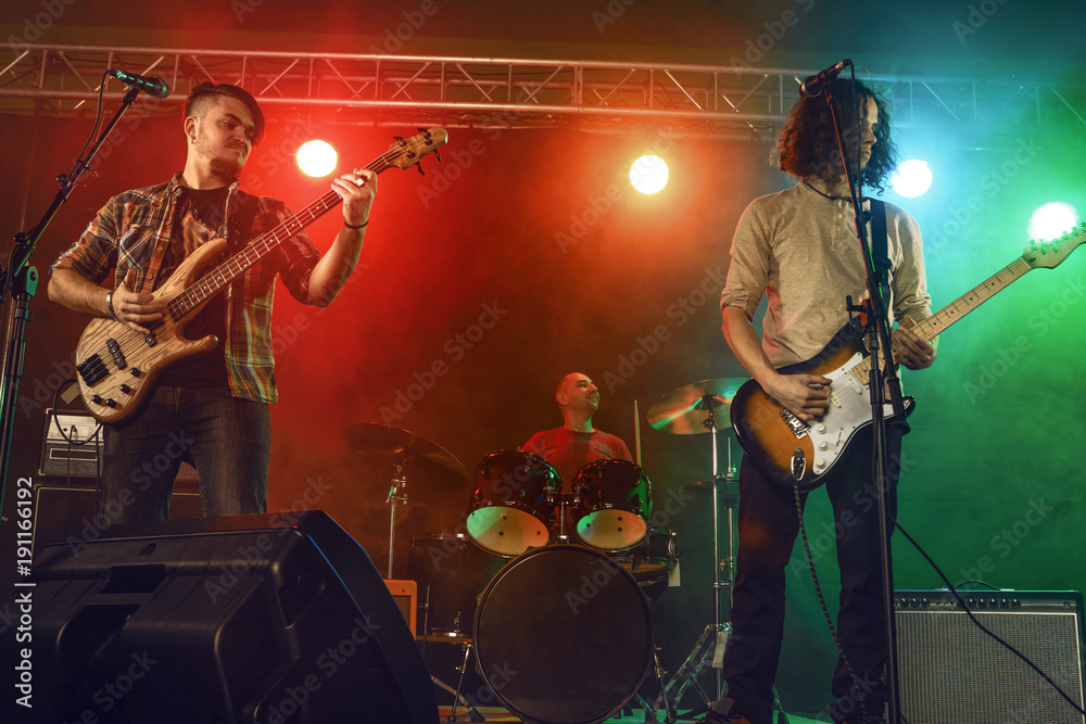 Obraz premium Rock band performs on stage.