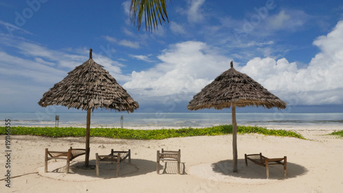 Bamboo huts on tropical island Zanzibar with turquoise sea © MyStockVideo