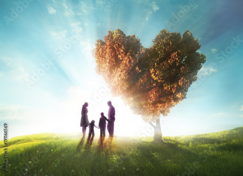 Foto Happy family with Heart shaped tree