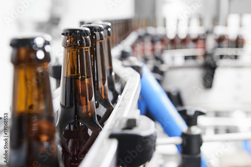 Brown beer bottles at a assembly line