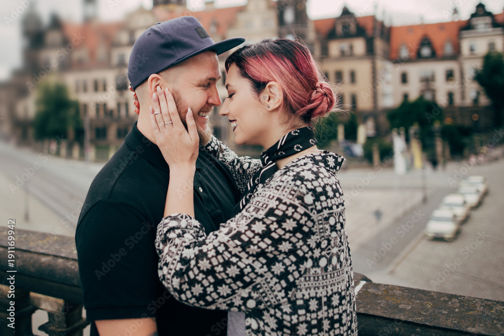 beautiful happy young couple hugging while standing on street in Dresden, Germany
