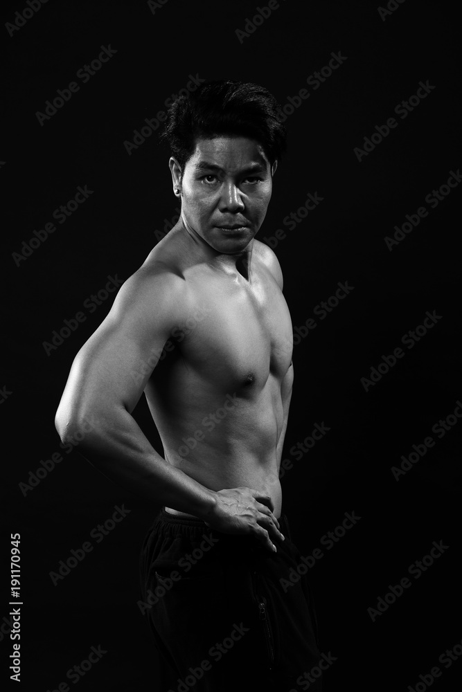 Naklejka premium Portrait of an athletic Asian Man, black and white photo