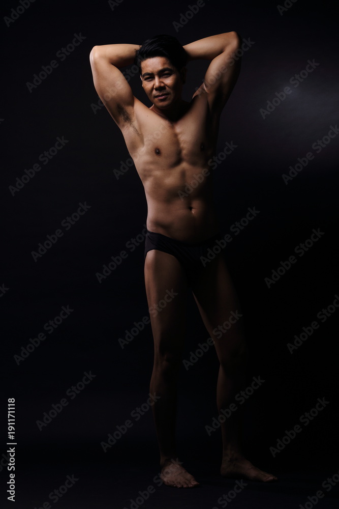 Naklejka premium Portrait of an athletic Asian Man, black and white photo