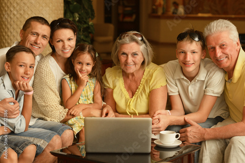 family sitting with digital devices