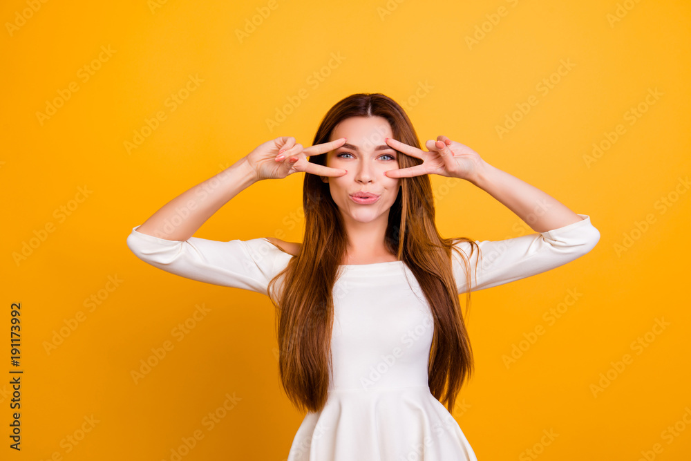 Portrait of beautiful attractive pretty charming cheerful joyful trendy stylish flirty stunning elegant woman with long straight hair demonstrating double v-sign isolated on background Portrait of beautiful attractive pretty charming cheerful joyful trendy stylish flirty stunning elegant woman with long straight hair demonstrating double v-sign isolated on background