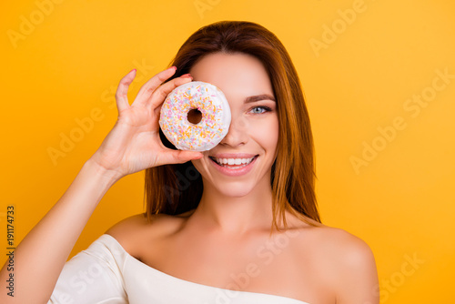 Diet, calories, healthcare, willpower, body care, concept, close up portrait of charming, cute girl with naked shoulders, holding sweet donut near eye, laughing, so playful and hungry, sexy and hot