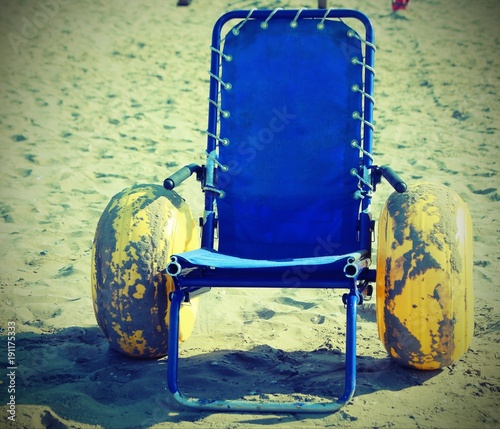 wheelchair with large yellow inflatable wheels photo