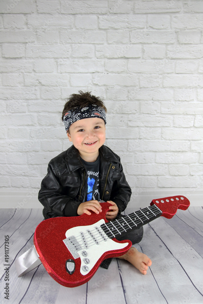 little child with a rock star costume with a rock guitar Stock Photo |  Adobe Stock