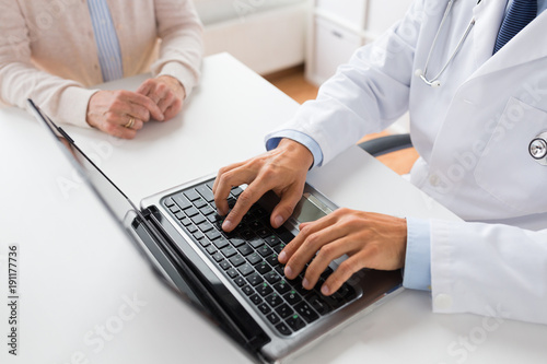 senior woman and doctor with laptop at hospital