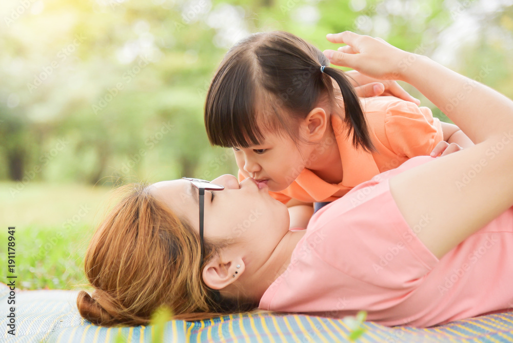 Asian kid is kissing to her young mother. Asian kid is kissing to her young mother.