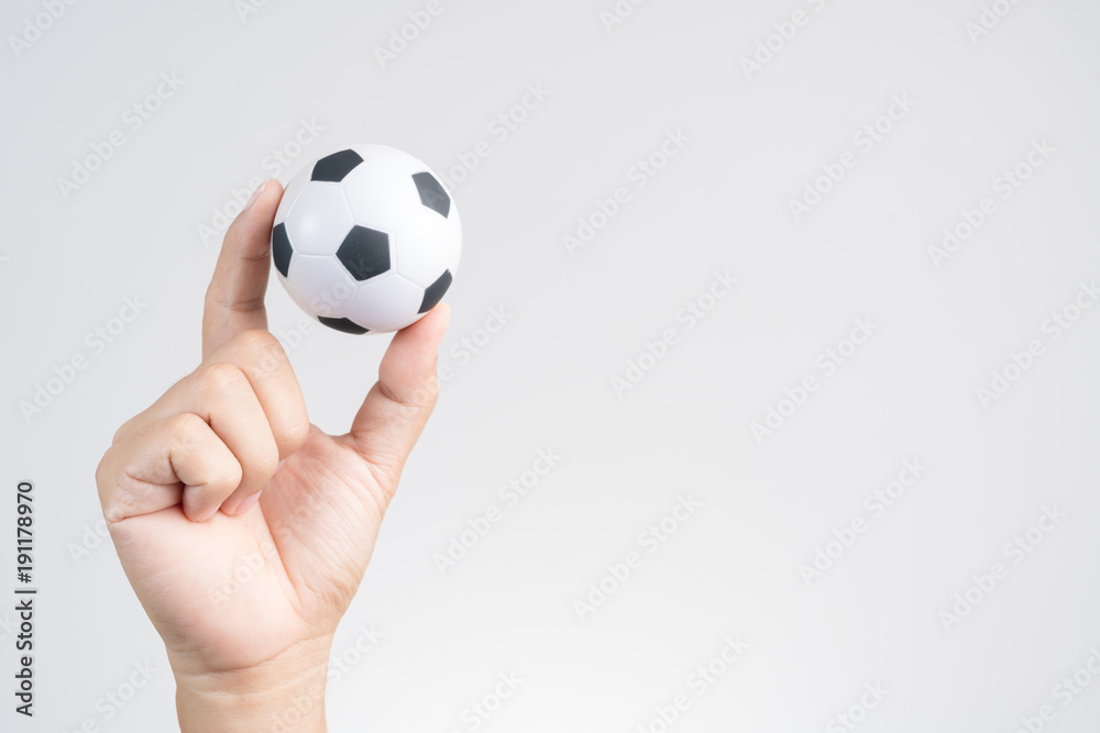 Obraz premium Hand holding small soccer ball or football