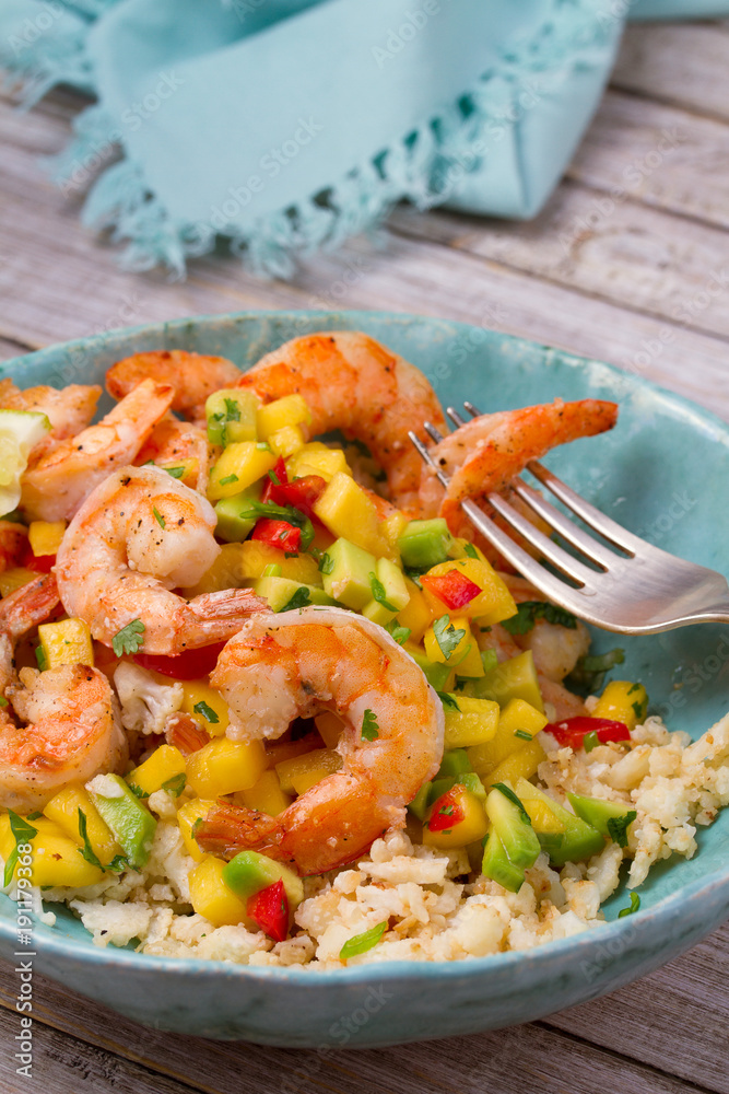Shrimps with mango avocado and red pepper salsa on cauliflower rice