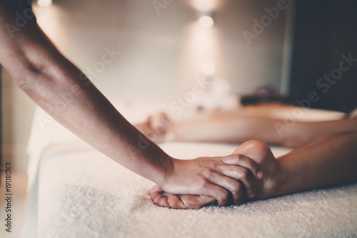 Masseur massaging masseuse during therapeutic tretment