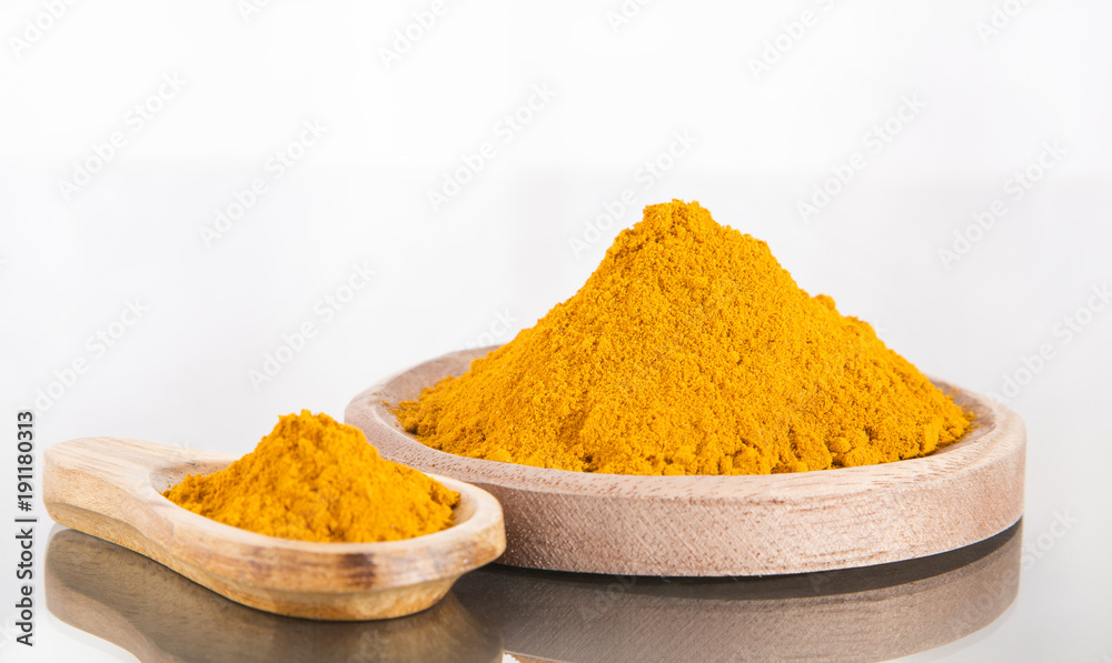 Organic turmeric powder on white background Organic turmeric powder on white background